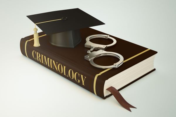 criminology book under graduation cap
