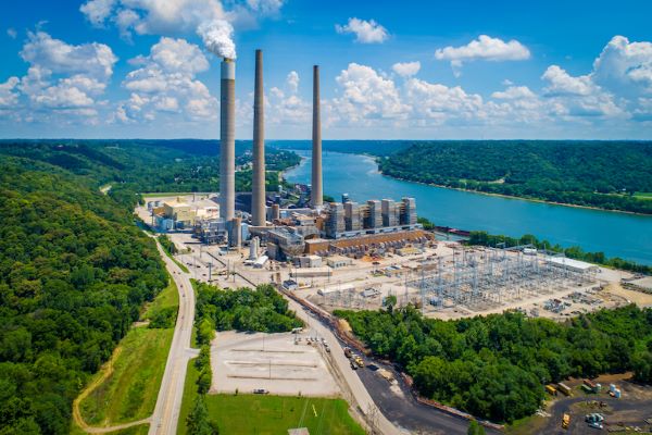 plant with smoke stacks near river