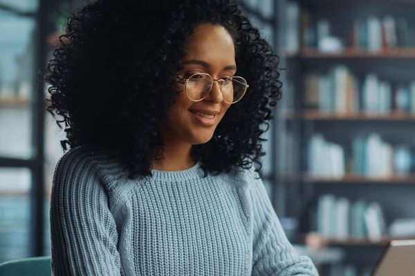 woman smiling at laptop