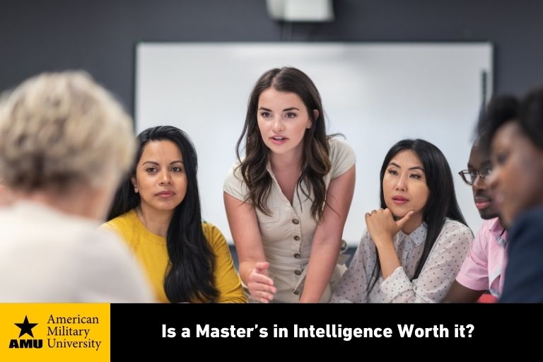 is-a-masters-in-intelligence-worth-it master's in intelligence graduate holding discussion in conference room