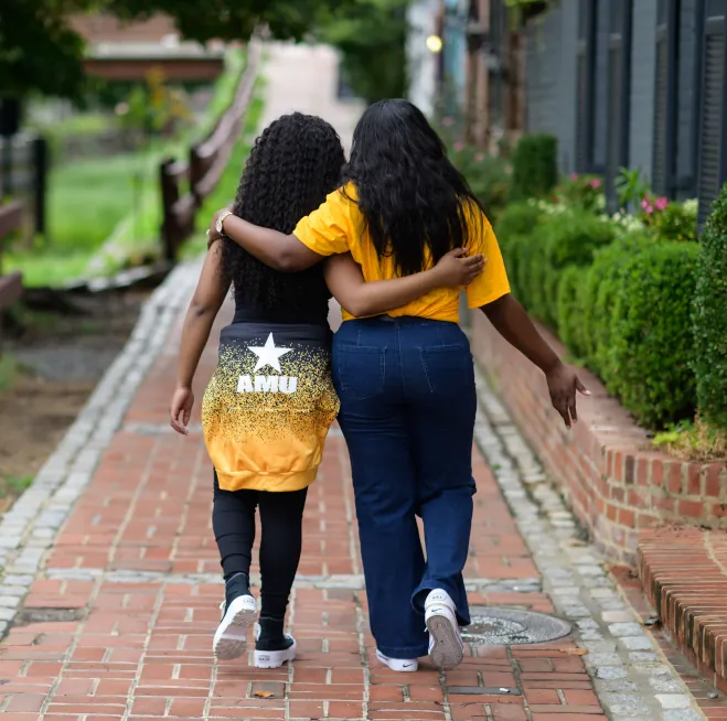 The Little family mother and daughter walking down the sidewalk