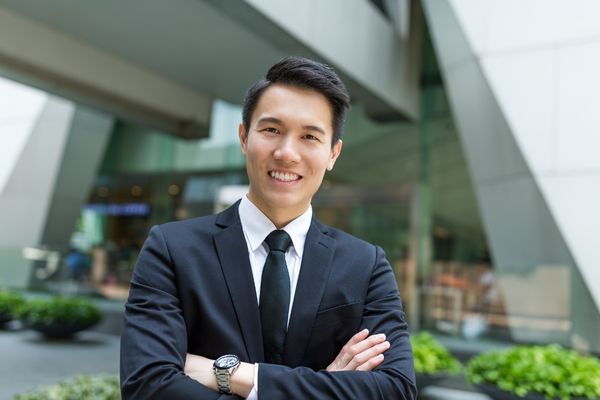 business intelligence analyst standing in front of corporate building