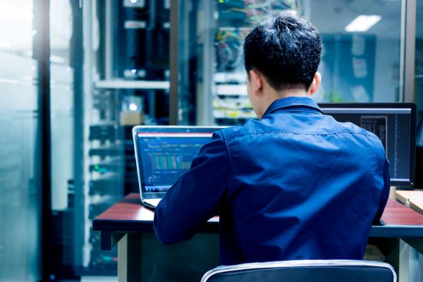 man sitting at computer